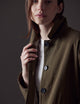 Woman wearing green button-up jacket from AETHER Apparel 