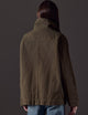 Back view of woman wearing green button-up jacket from AETHER Apparel 