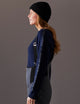 woman wearing dark blue sweater from AETHER Apparel