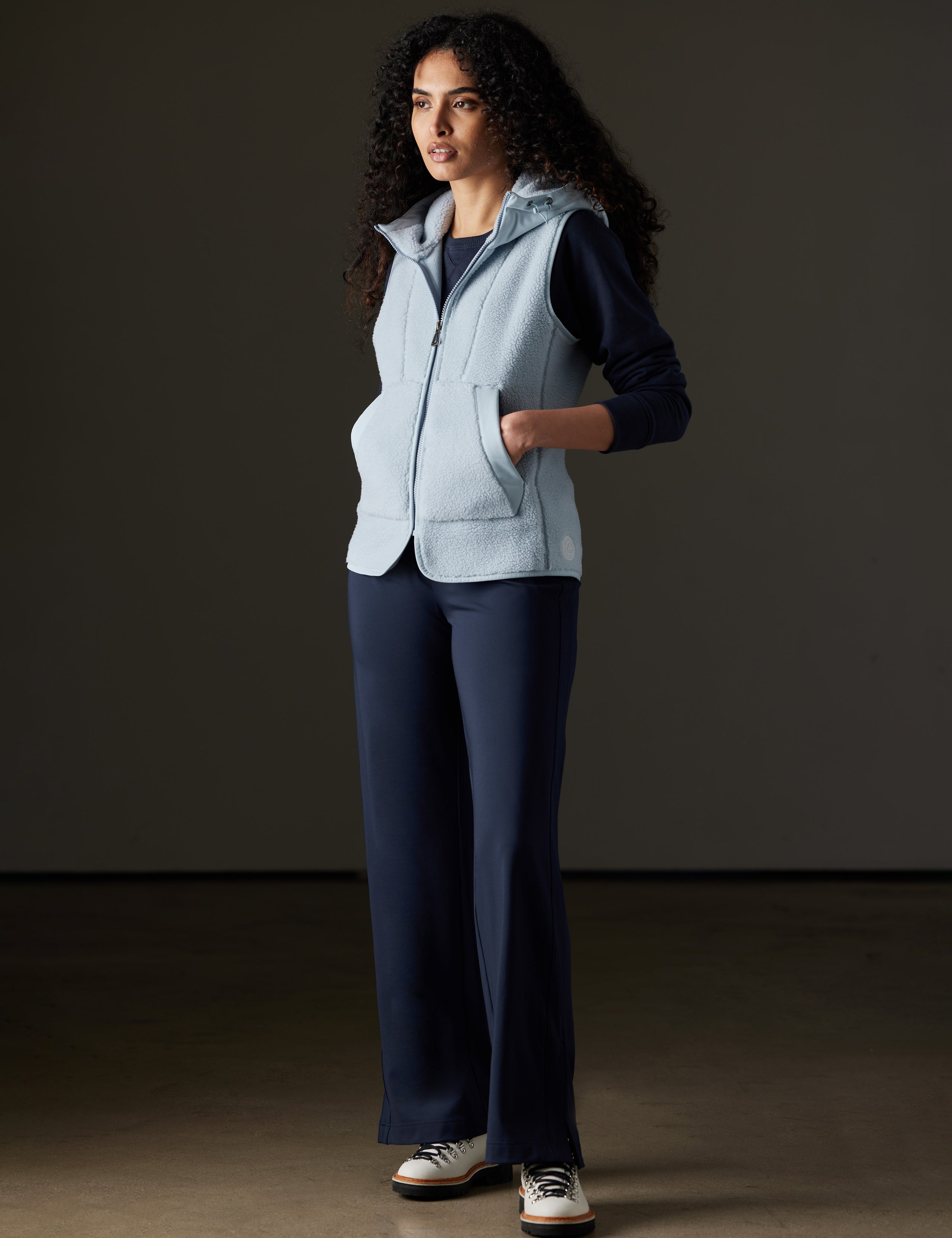 Woman wearing blue fleece vest from AETHER Apparel