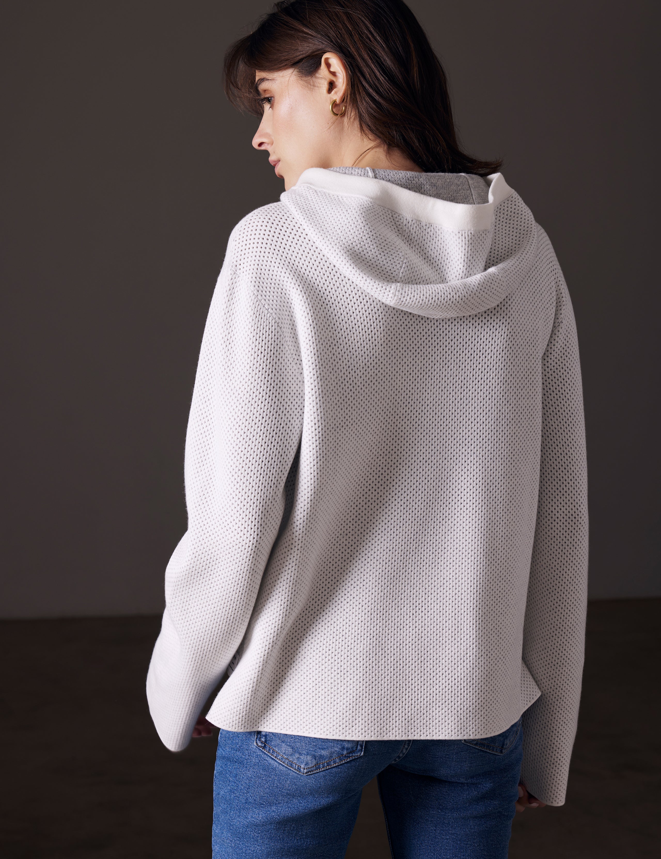 back view of woman wearing beige sweater from AETHER Apparel