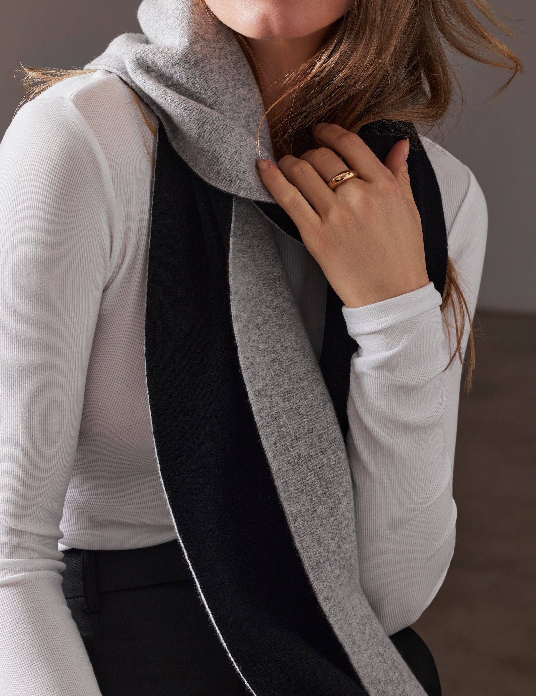 woman wearing cashmere scarf with grey front and black back