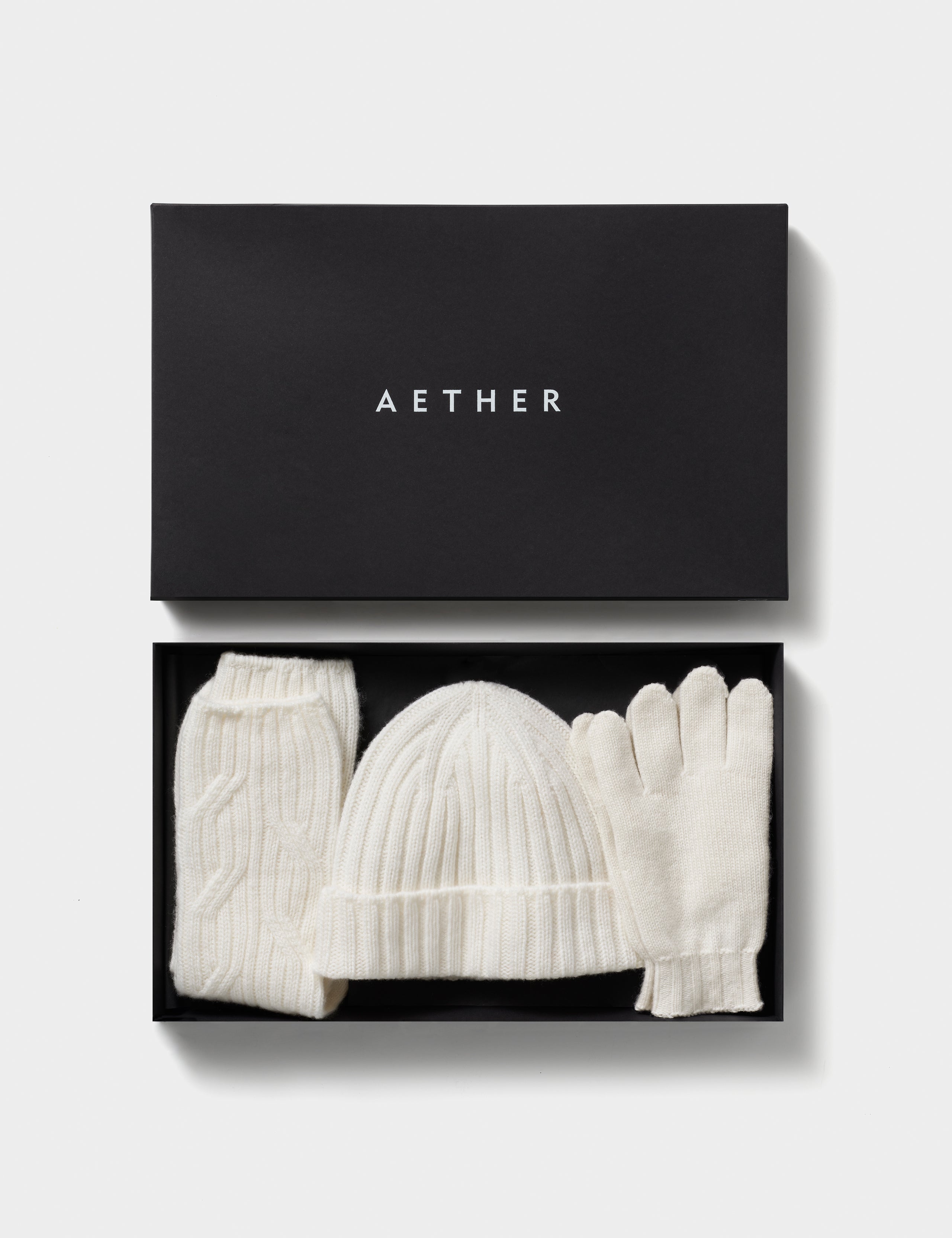 White cashmere hat, socks, and gloves from AETHER Apparel