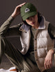 woman wearing green AETHER Mountain Hat