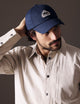 man wearing blue AETHER Mountain Hat