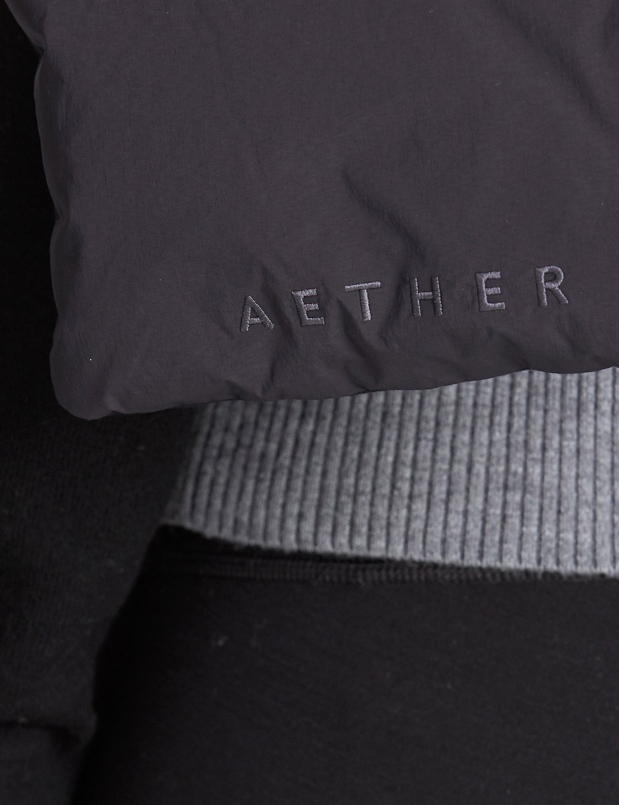 AETHER logo on black quilted down scarf