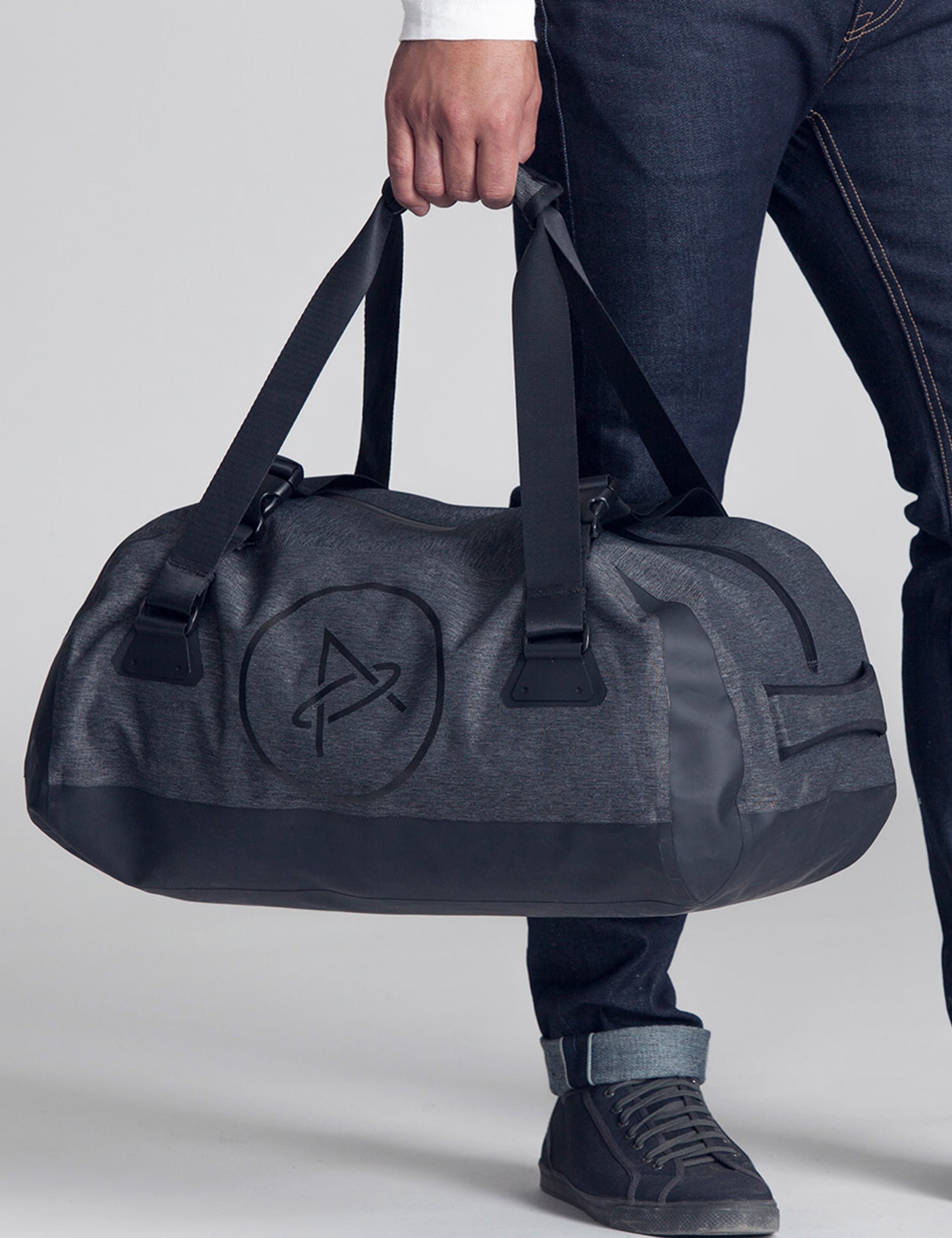 man holding grey duffle bag from AETHER Apparel