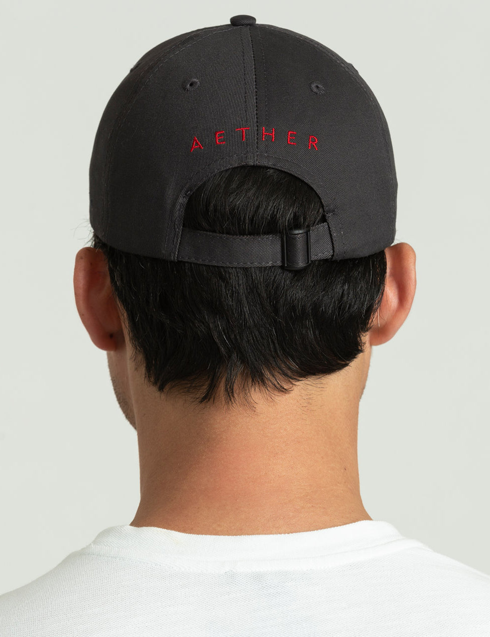 back view of man wearing dark grey hat from AETHER Apparel