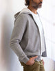 man wearing a light grey full zip hoodie