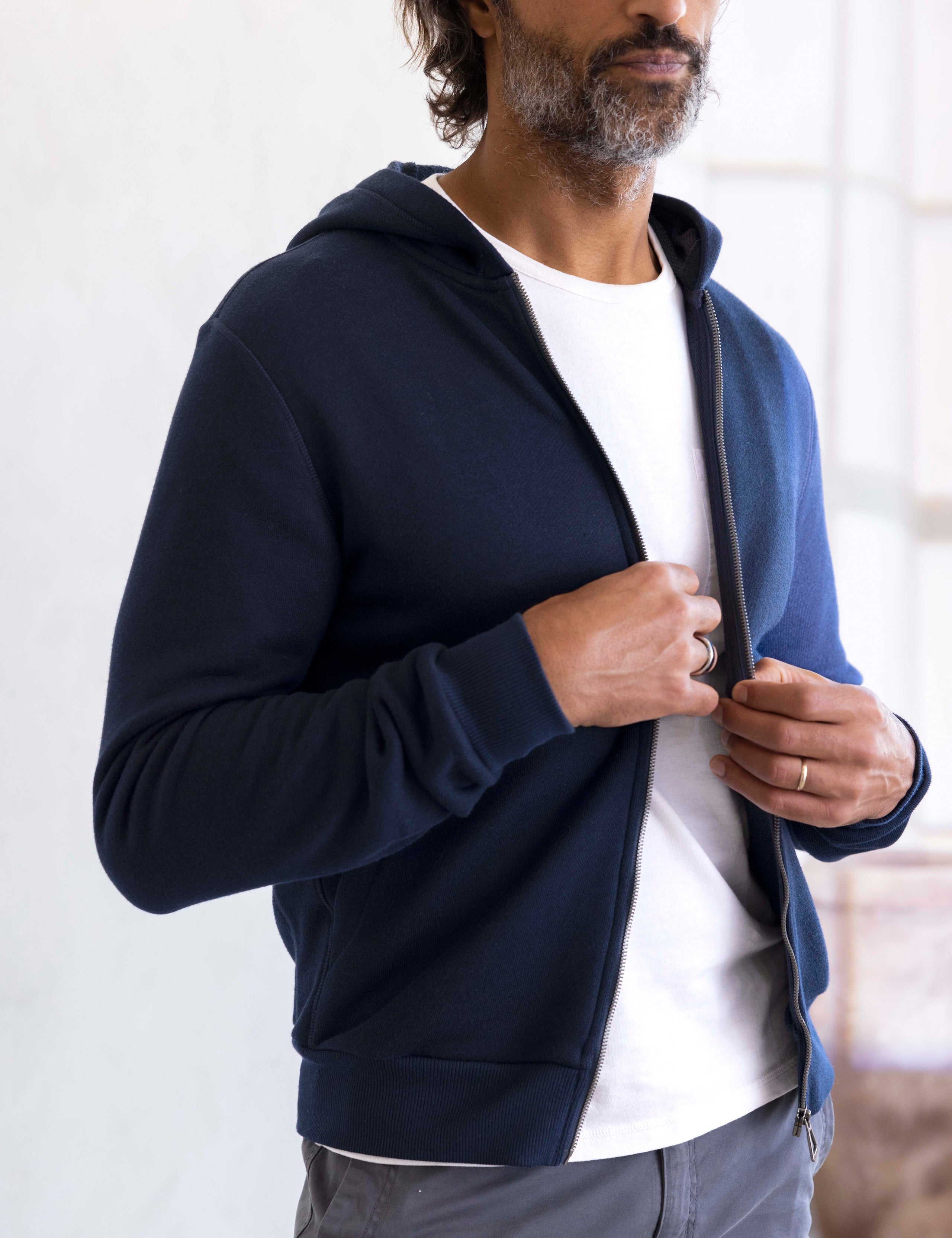 man wearing a navy full zip hoodie