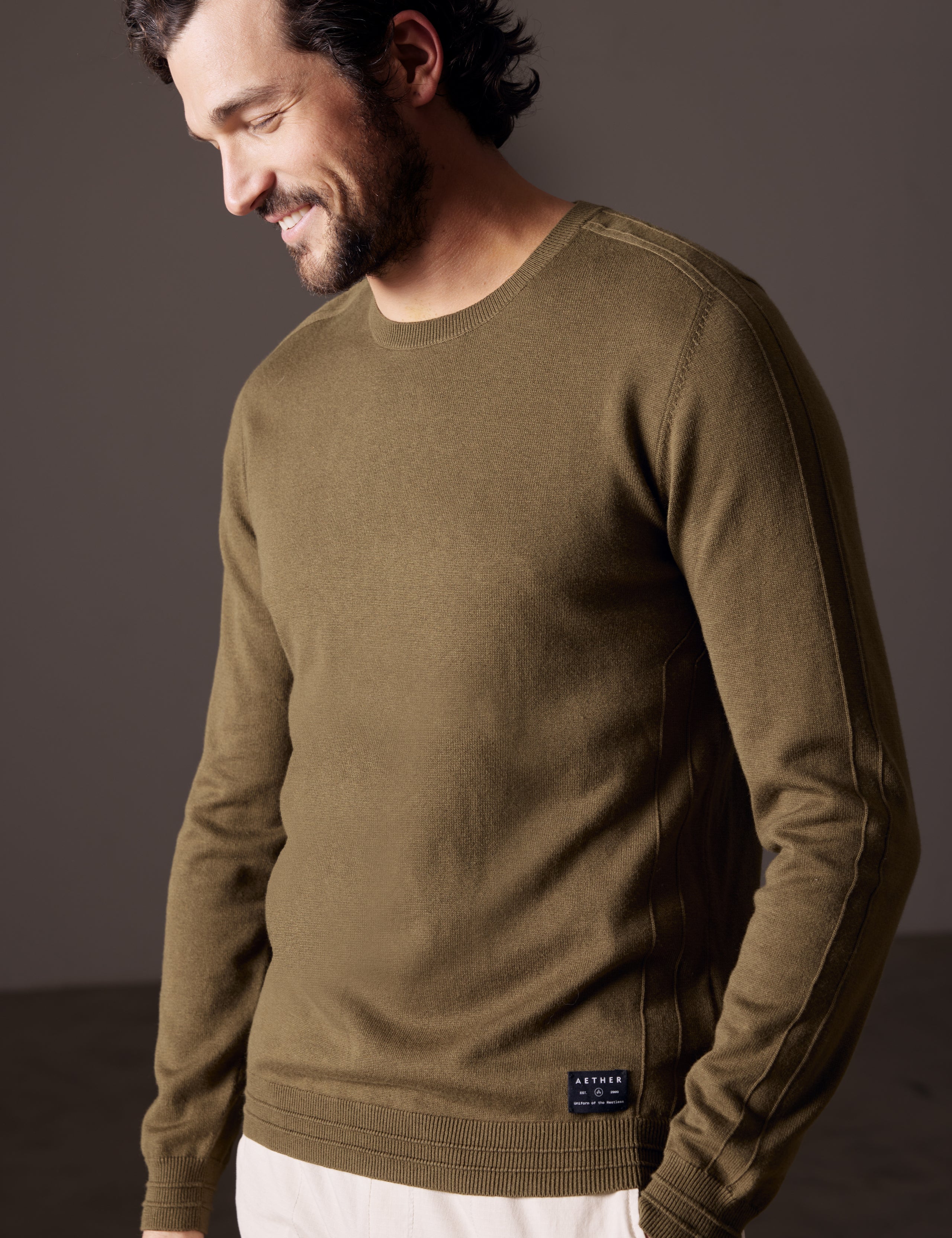 Man wearing green sweater from AETHER Apparel