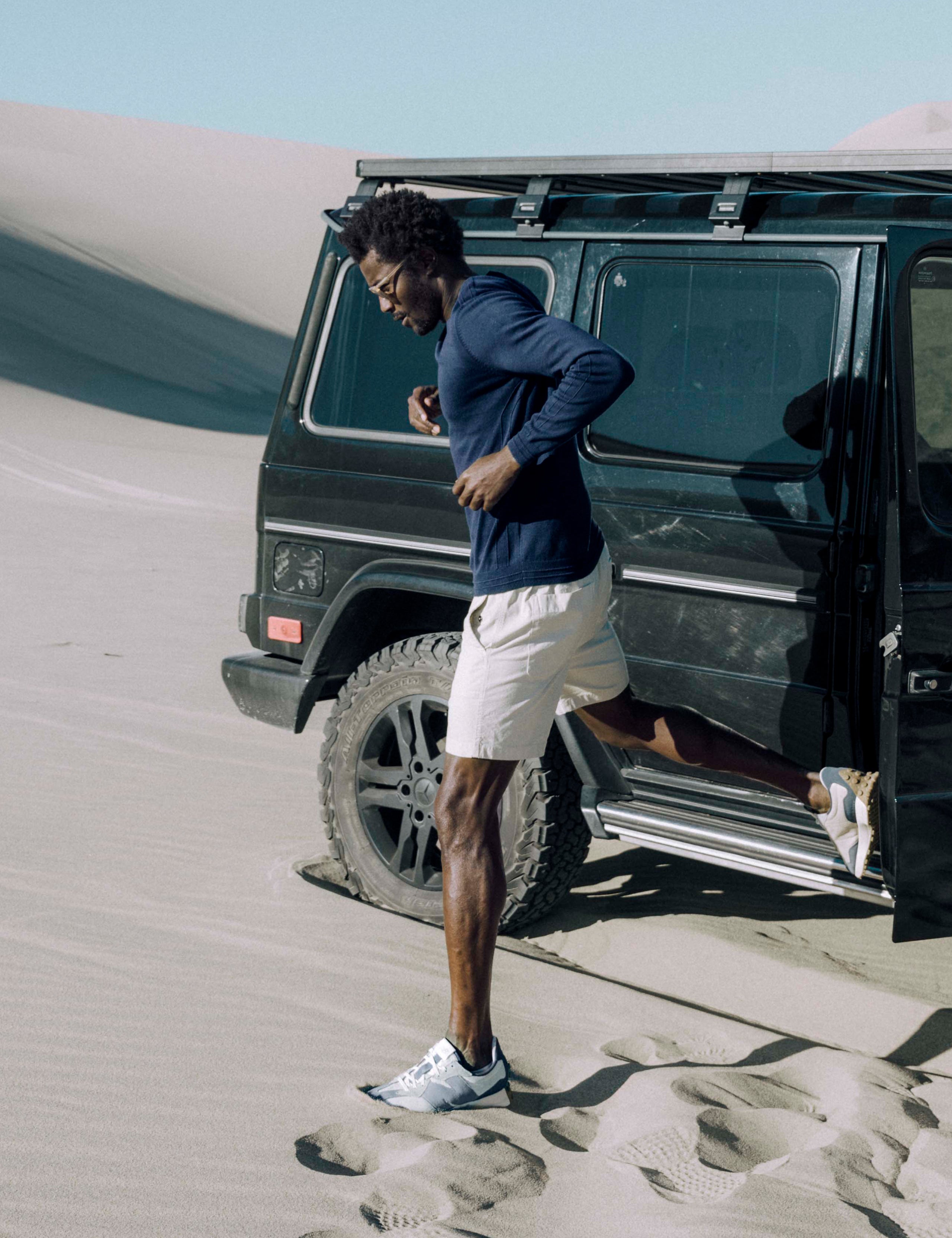 Man outside of truck wearing blue sweater