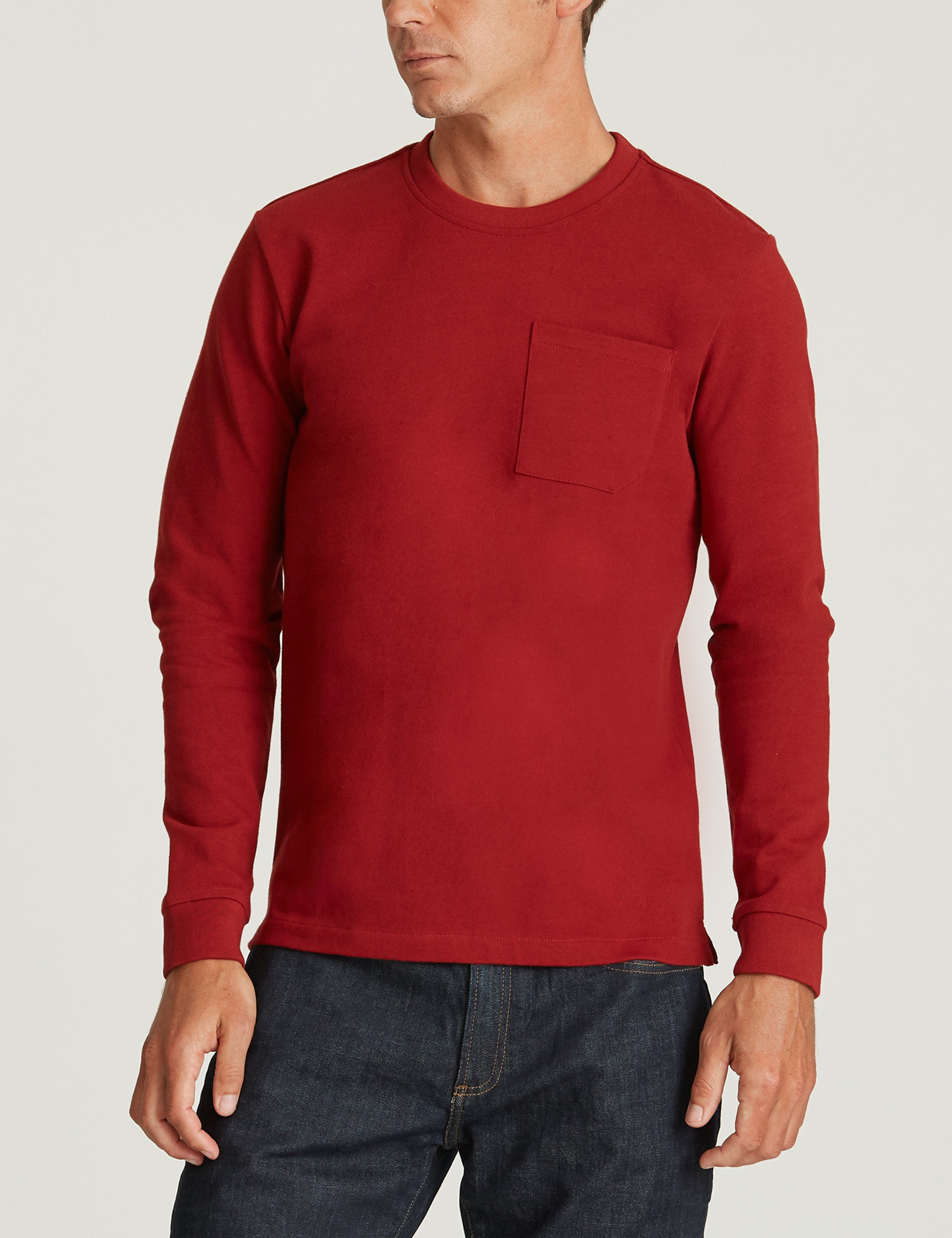 man wearing red long sleeve shirt with pocket