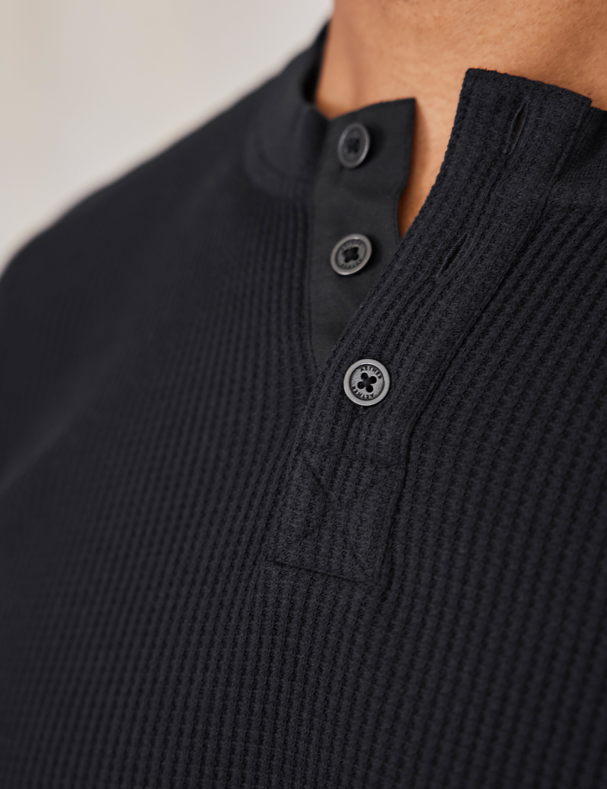 man wearing black long sleeve henley