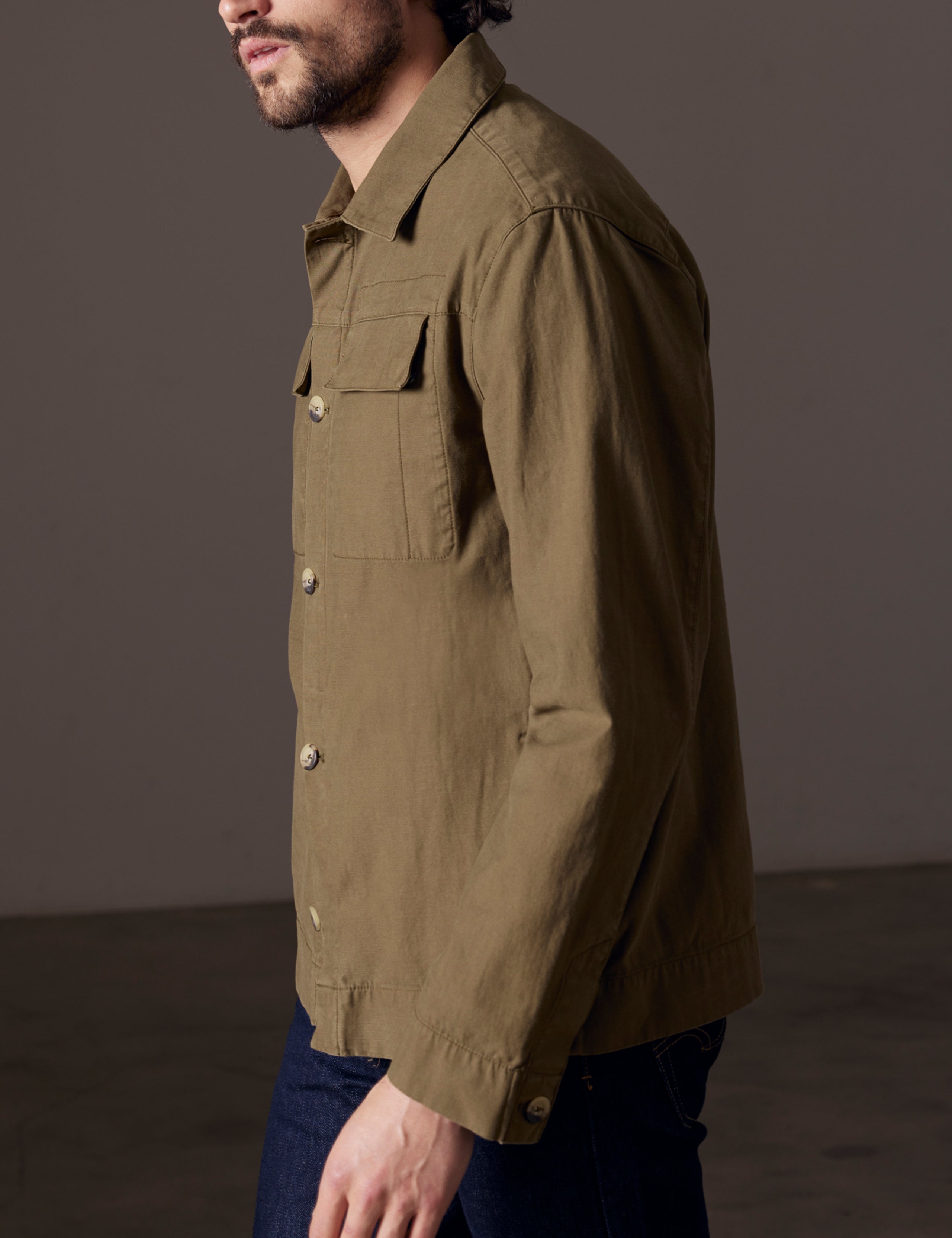 Side view of man wearing green shirt jacket