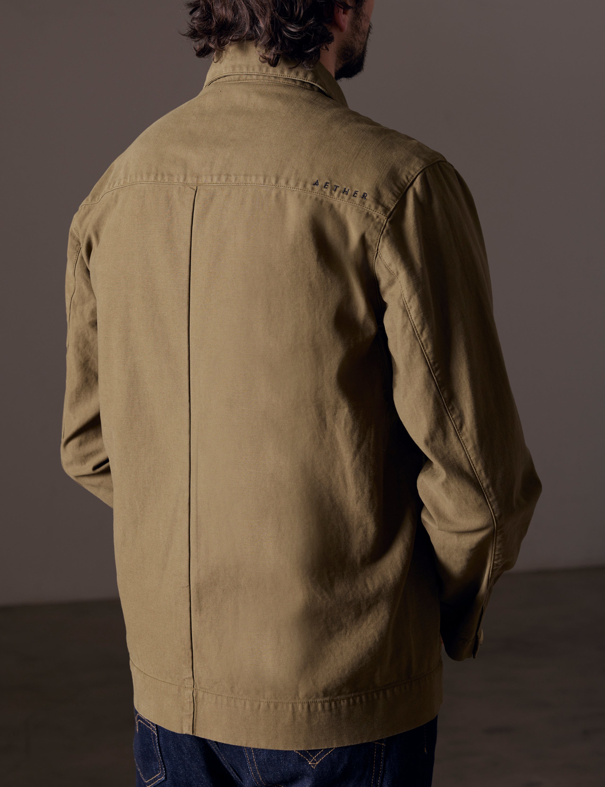 Back view of man wearing green shirt jacket