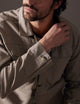 Close-up of man wearing light grey shirt jacket from AETHER Apparel