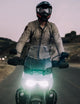 man on motorcycle wearing tan jacket