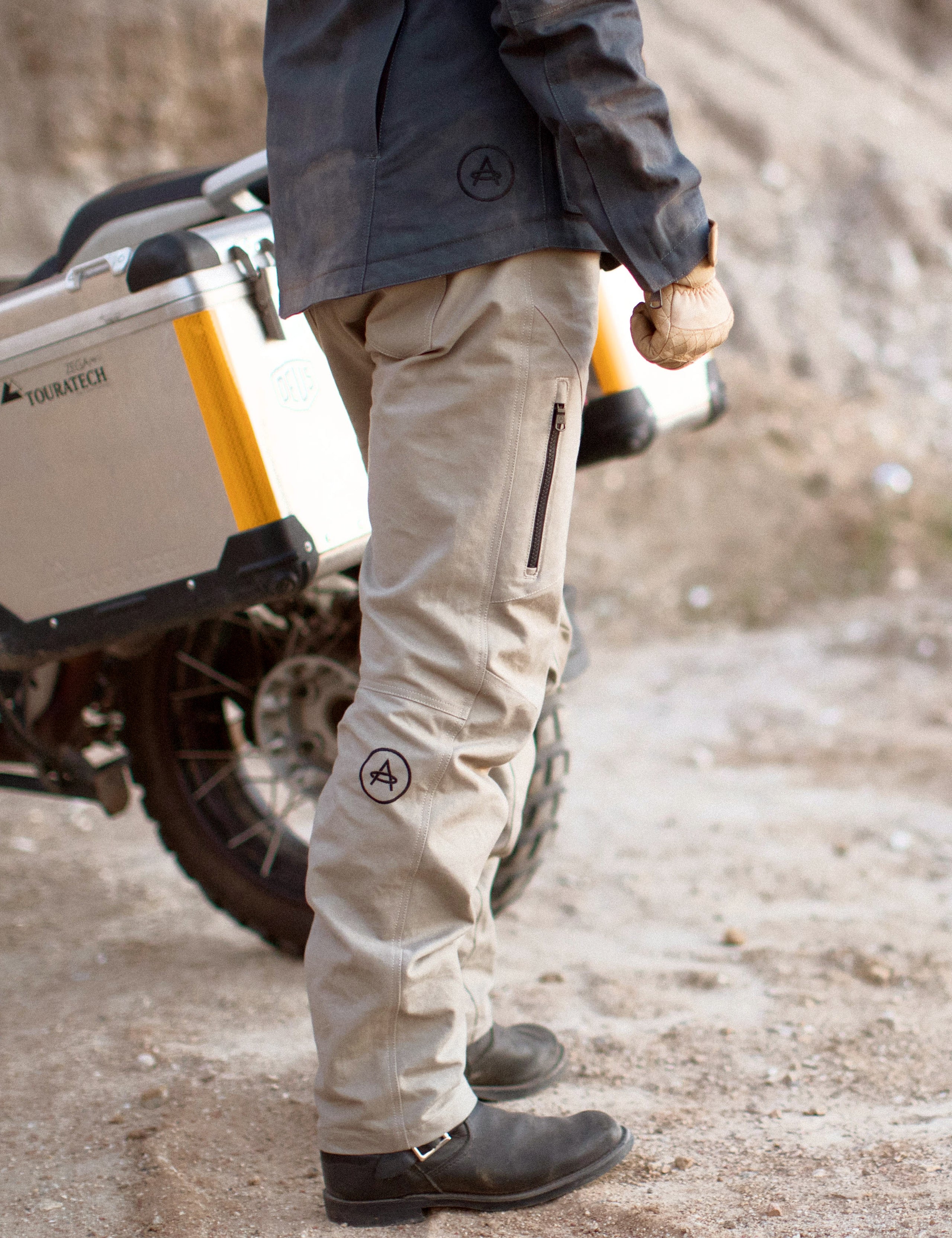 man wearing tan motorcycle pants