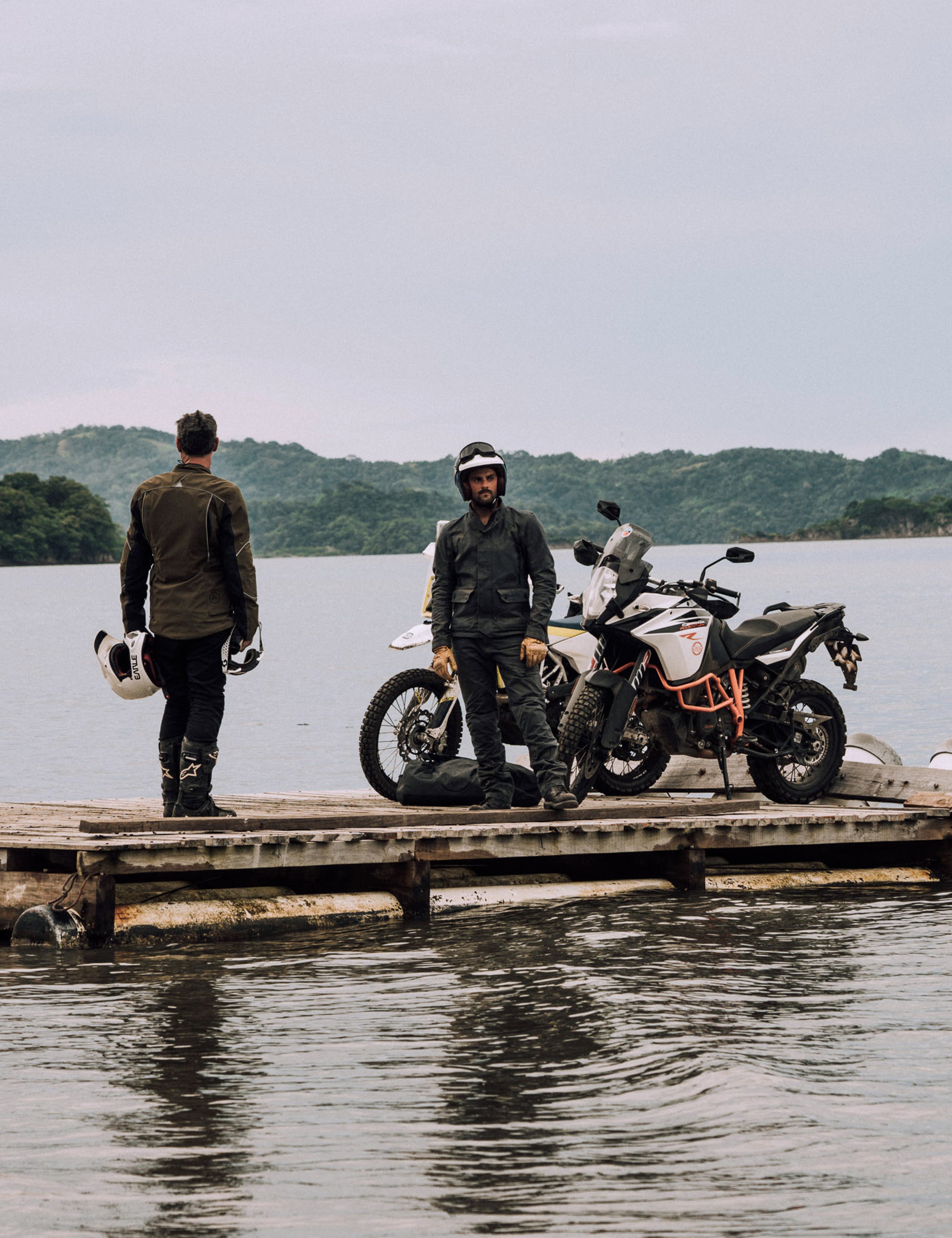 men standing near motorcycle