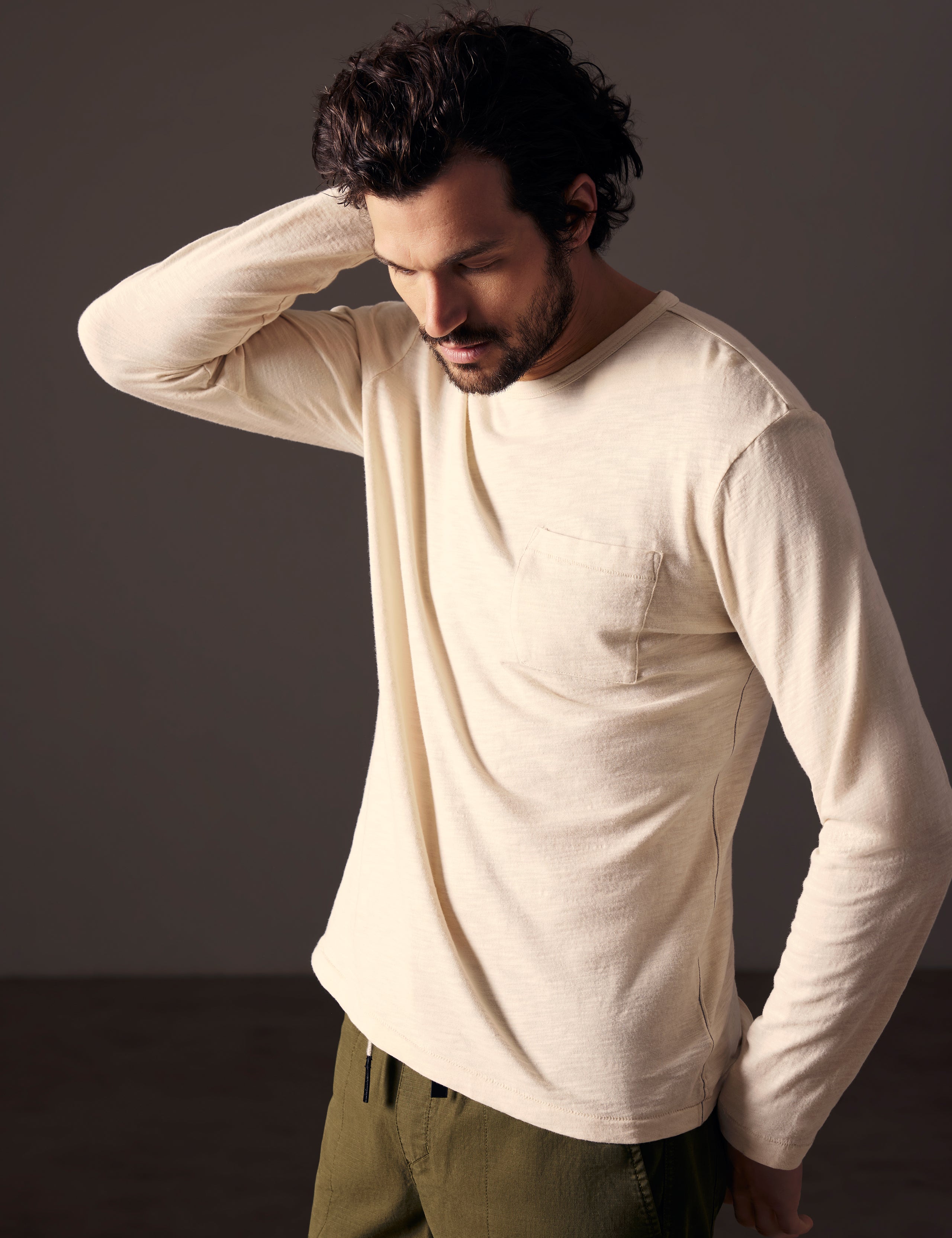 man wearing beige long-sleeve tee from AETHER Apparel