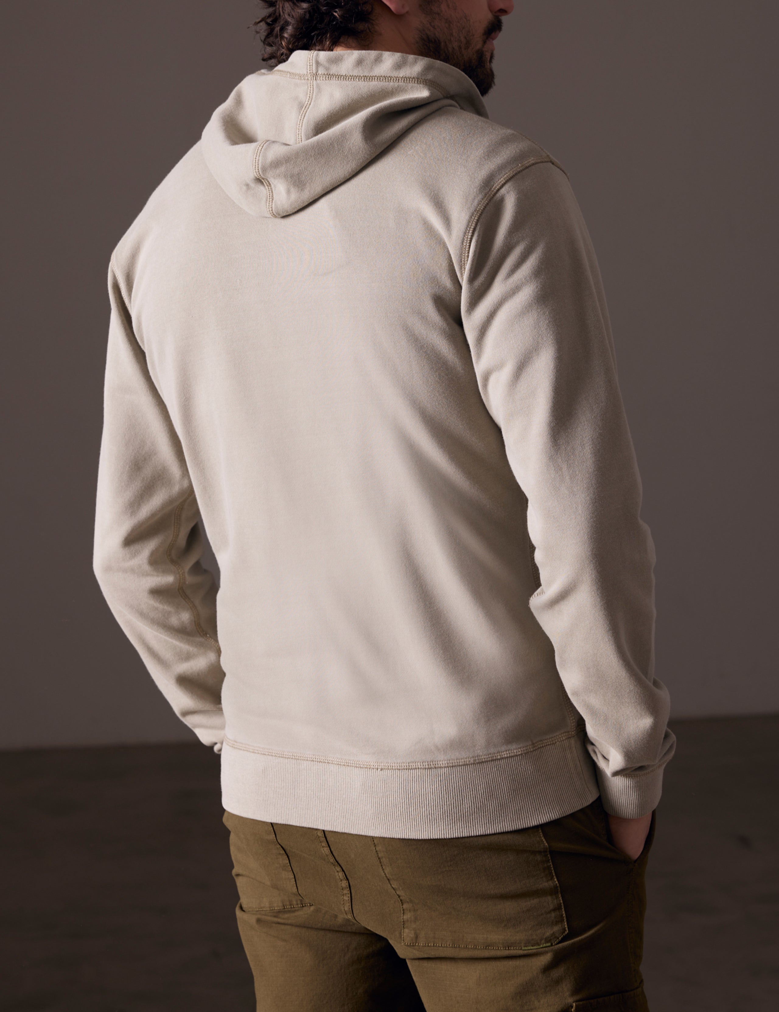 Back view of man wearing full-zip hoodie
