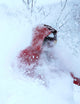 man wearing red ski jacket in snow