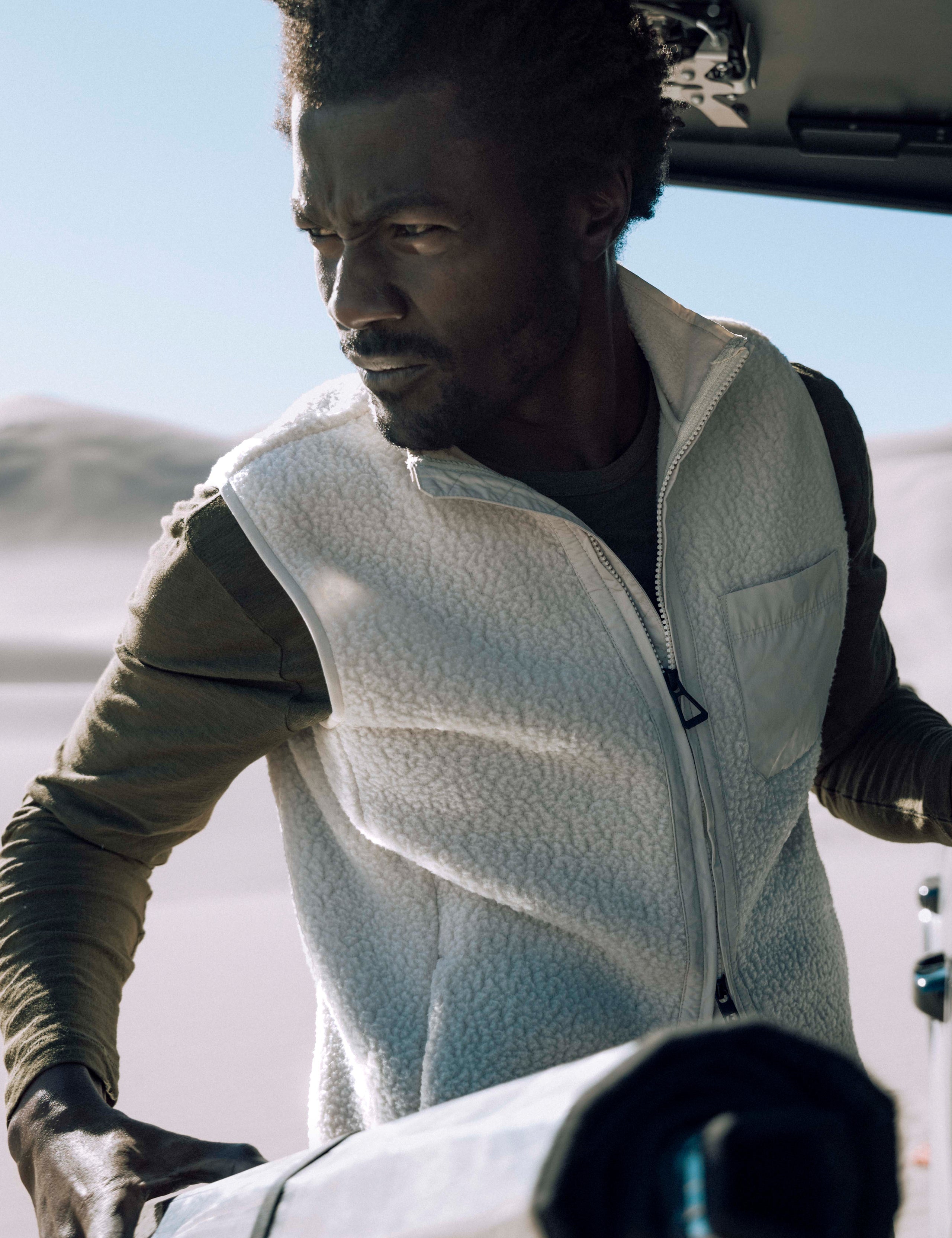 man wearing beige fleece vest