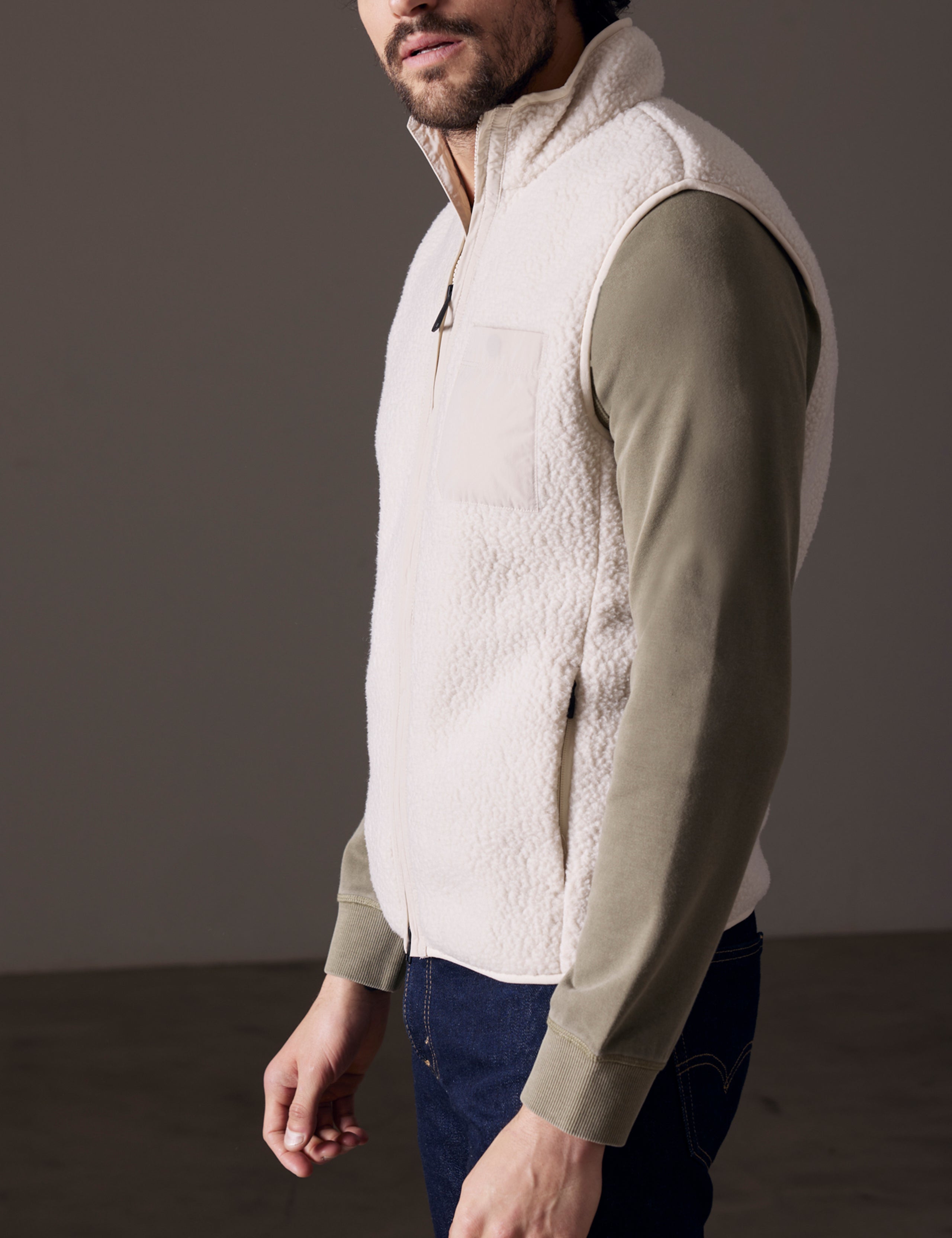 man wearing beige fleece vest