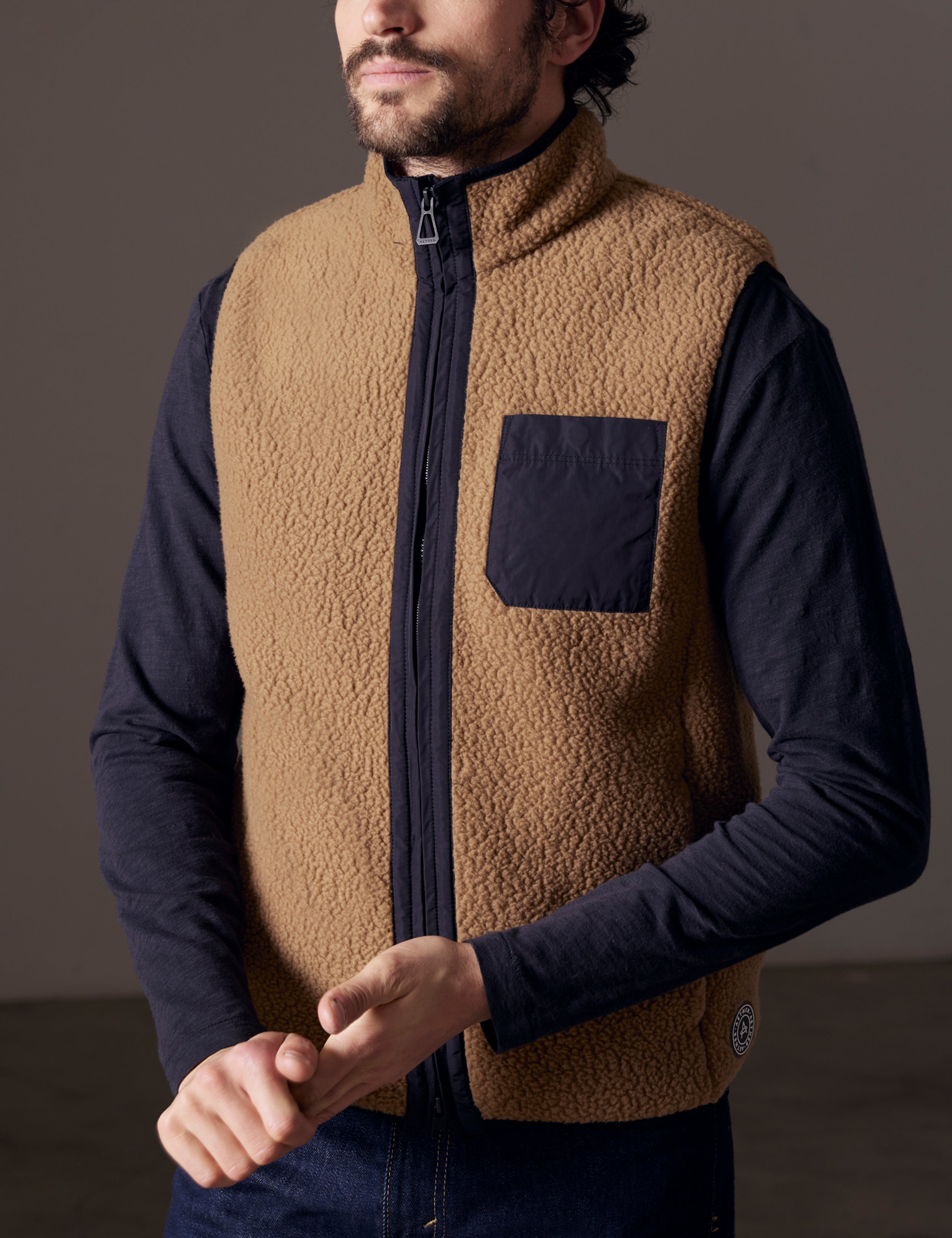 man wearing brown fleece vest
