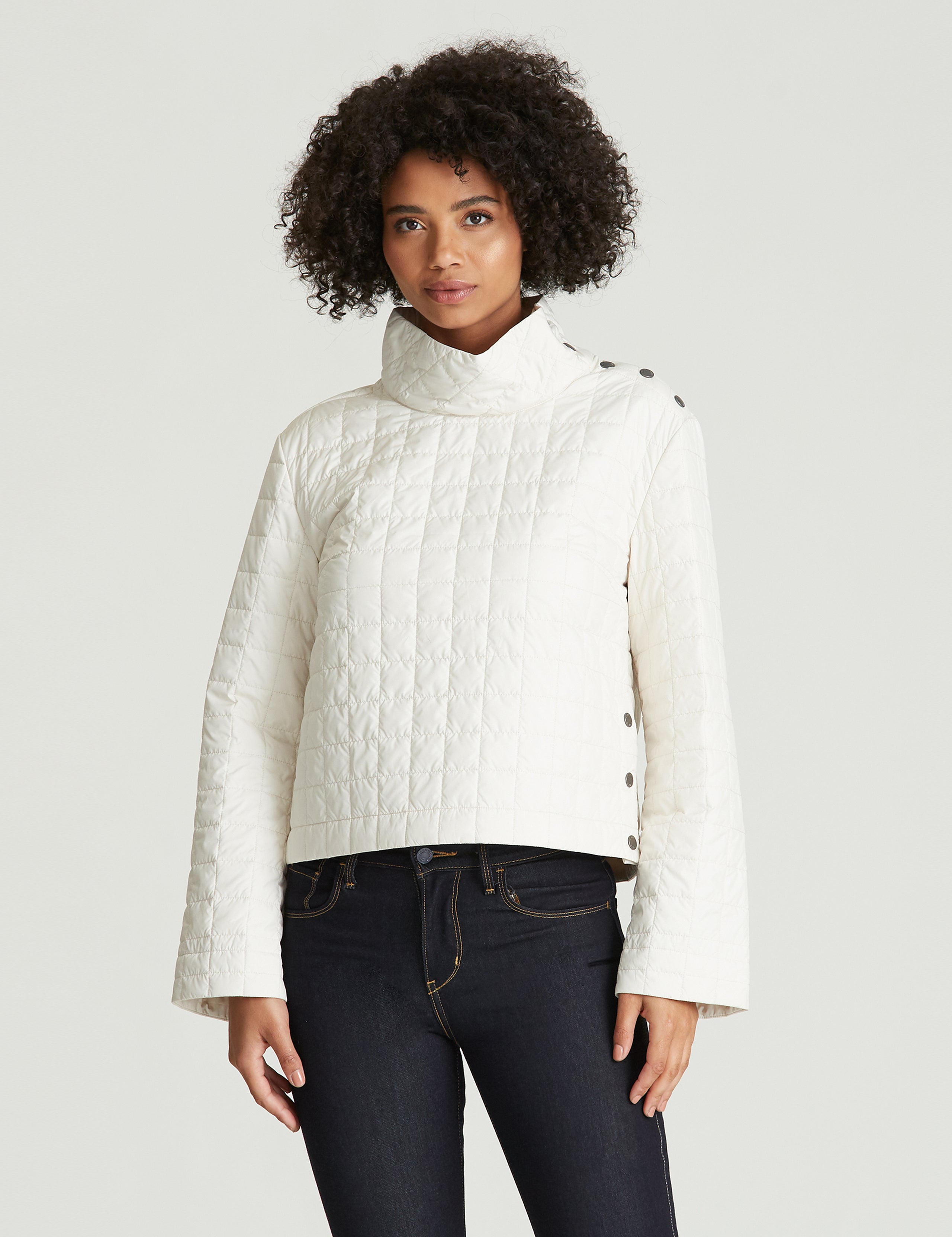 woman wearing quilted beige pullover