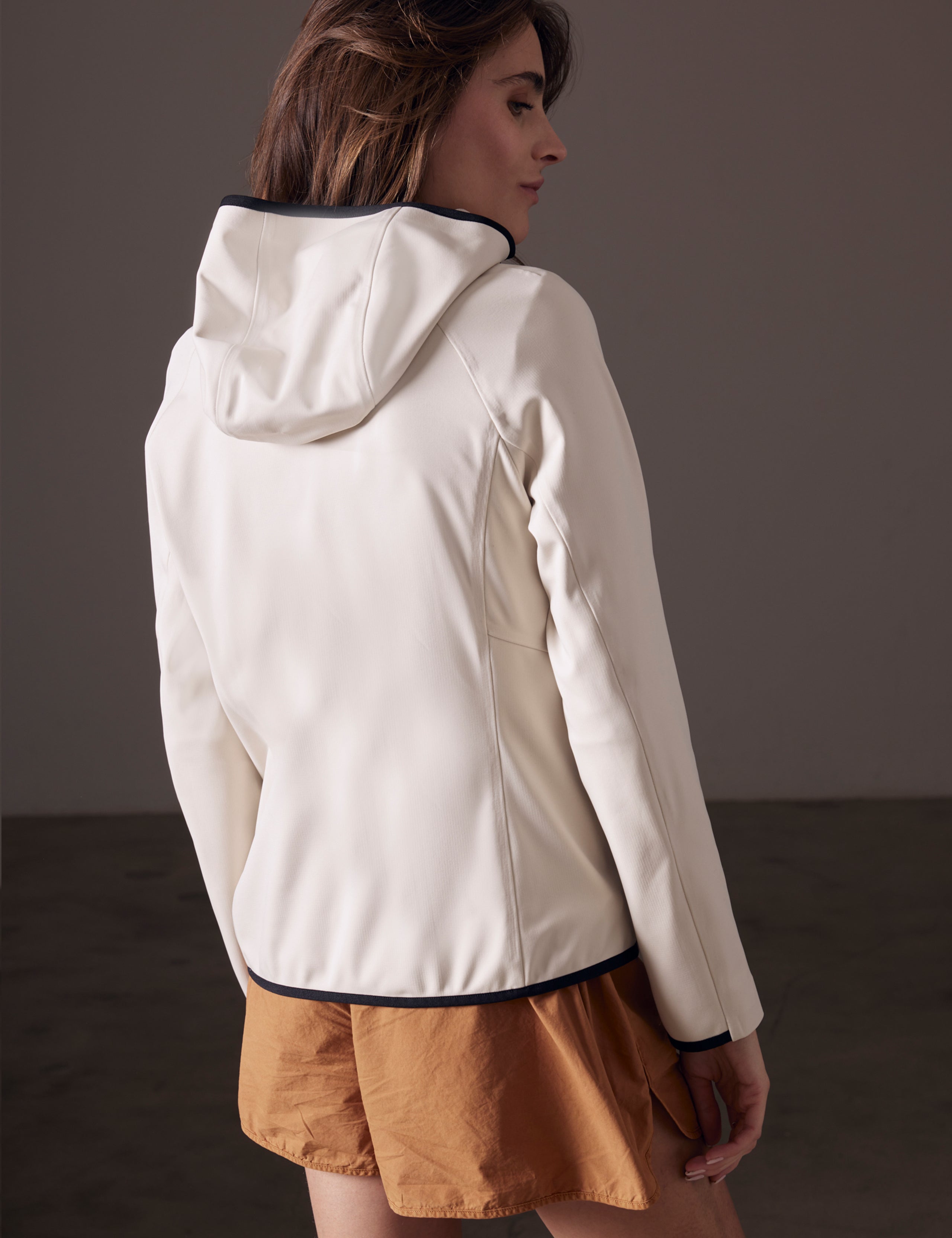 back view of woman wearing beige fleece full-zip