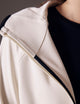 close up of woman wearing beige fleece full-zip