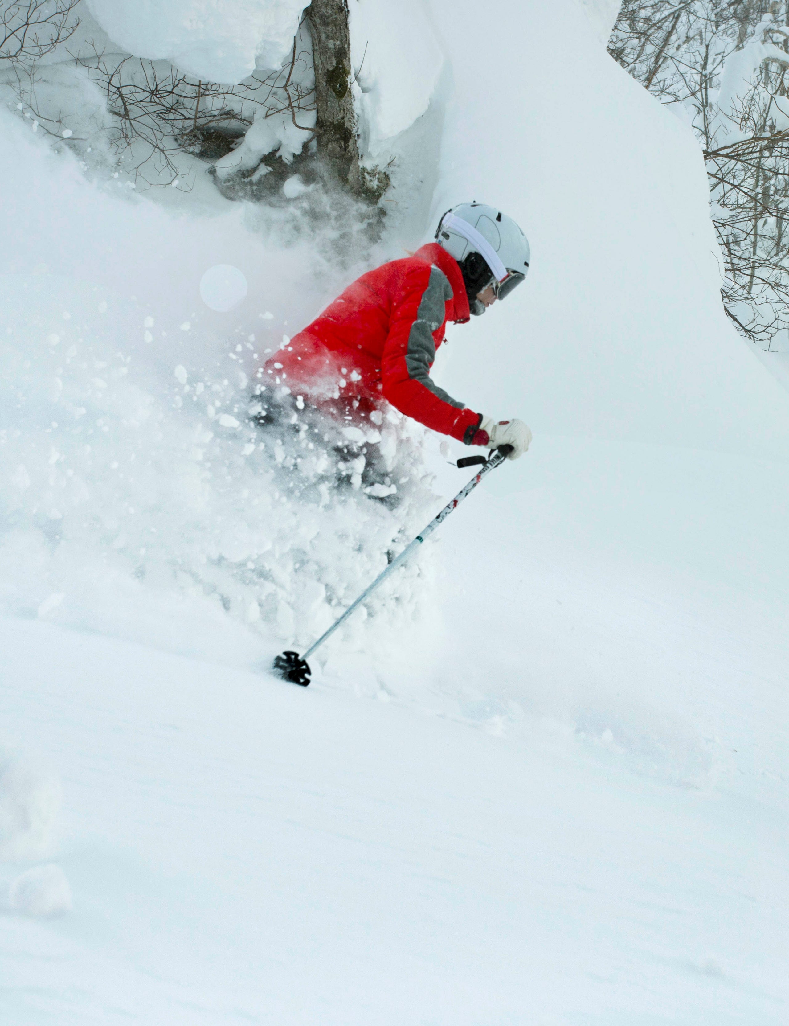 Woman skiing in deep powder snow in Hokkaido, Japan