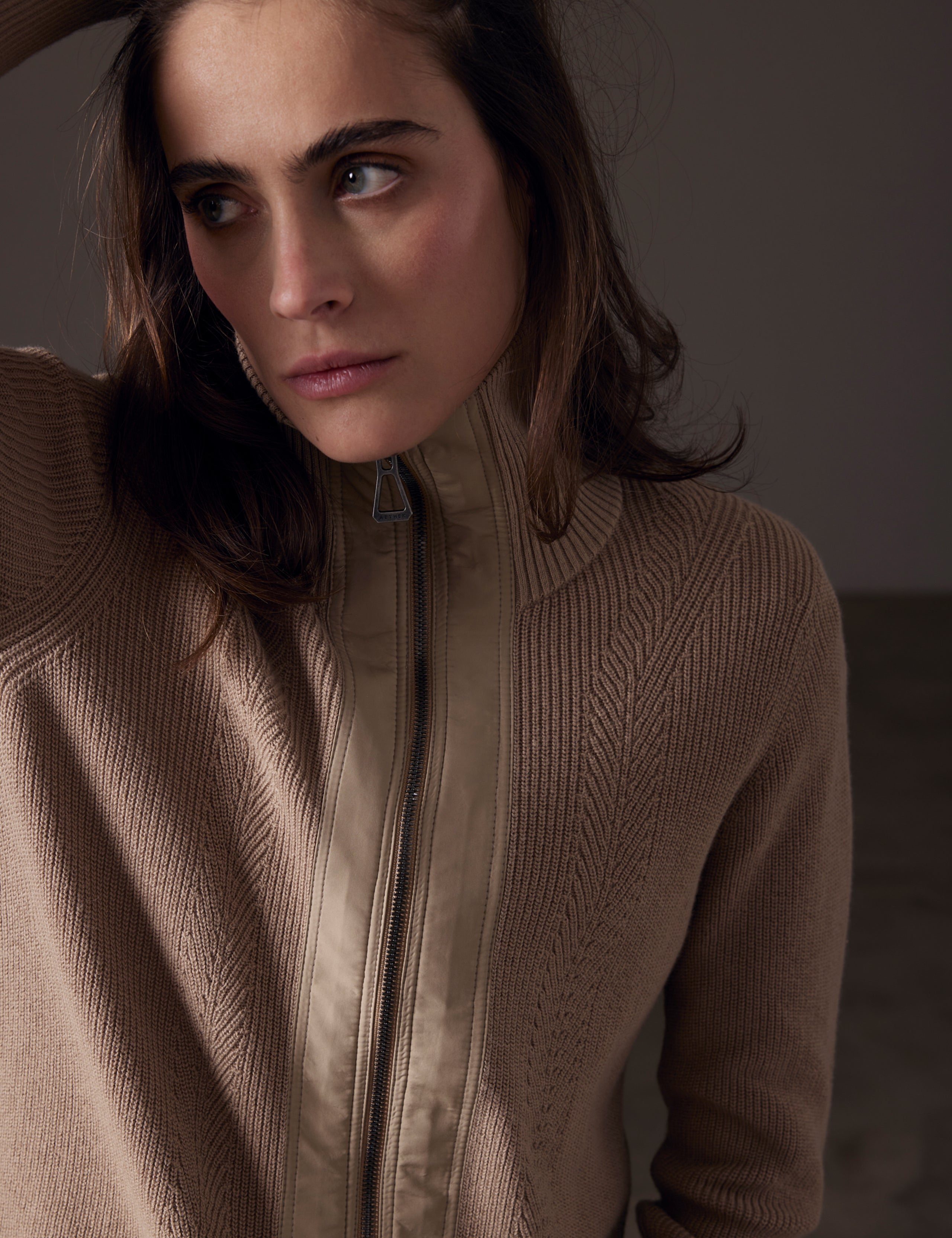 Woman wearing brown full-zip sweater