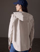 back view of woman wearing beige waterproof jacket