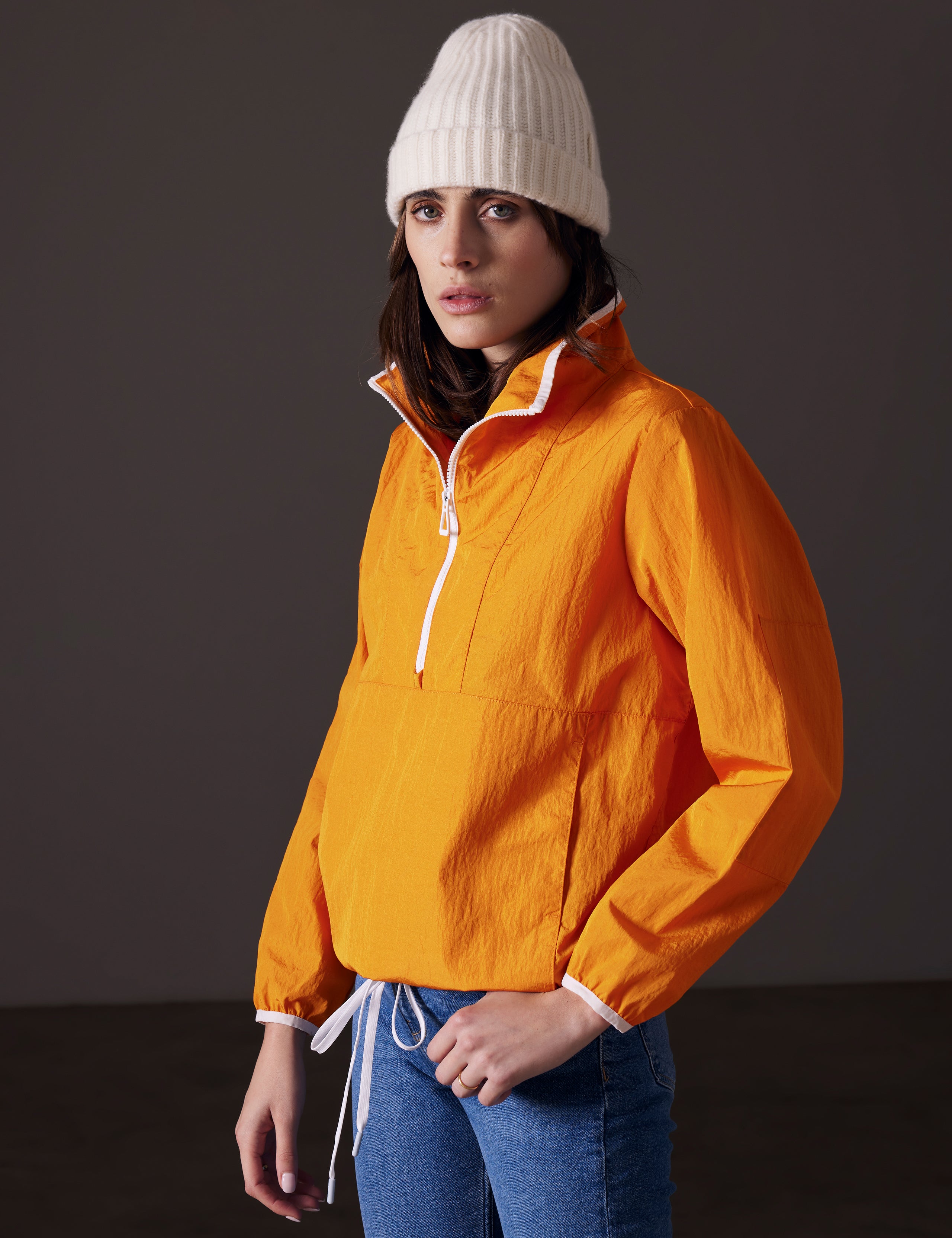 woman wearing light orange anorak from AETHER Apparel