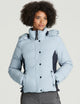 woman wearing light blue ski jacket from Aether Apparel