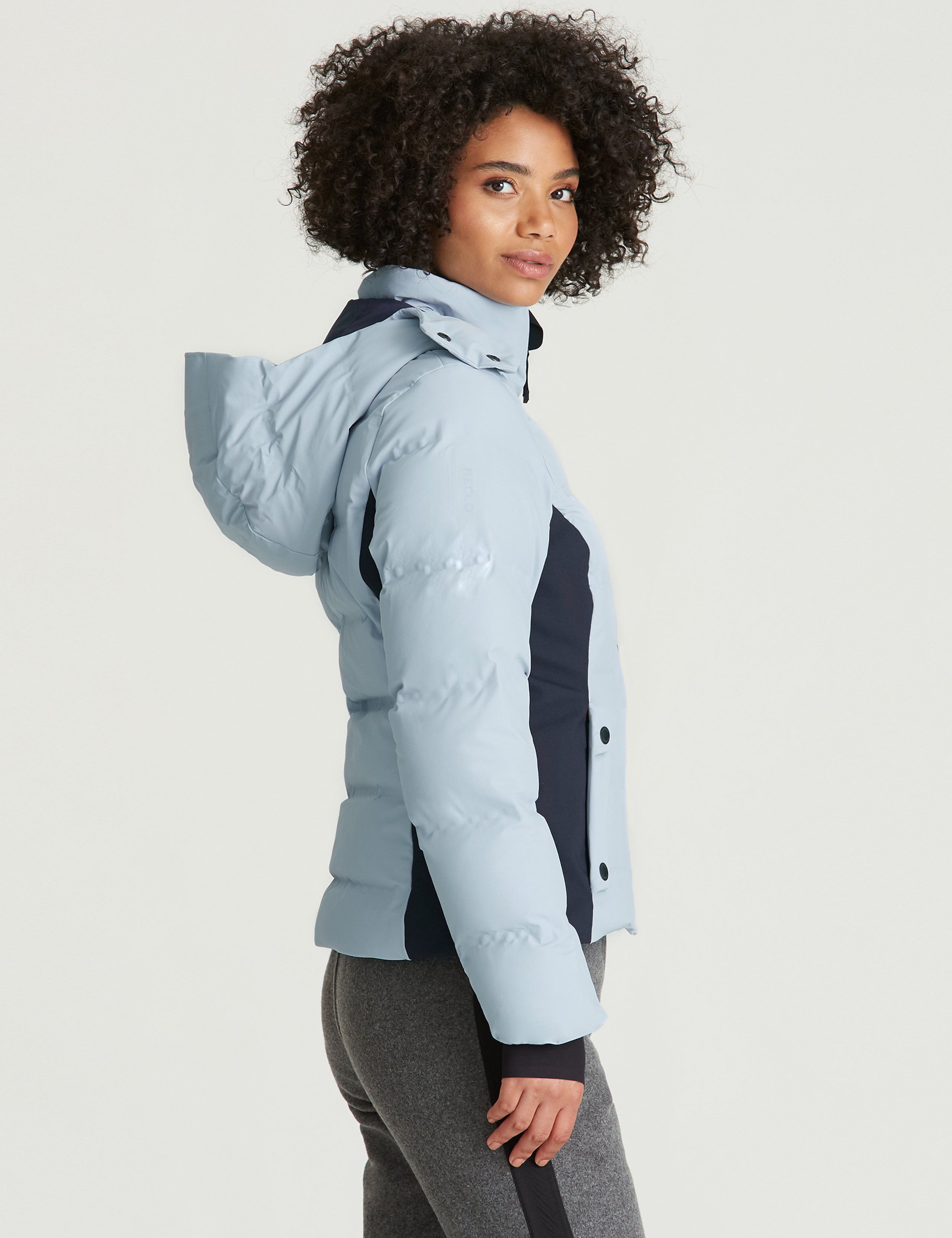 woman wearing light blue ski jacket from Aether Apparel
