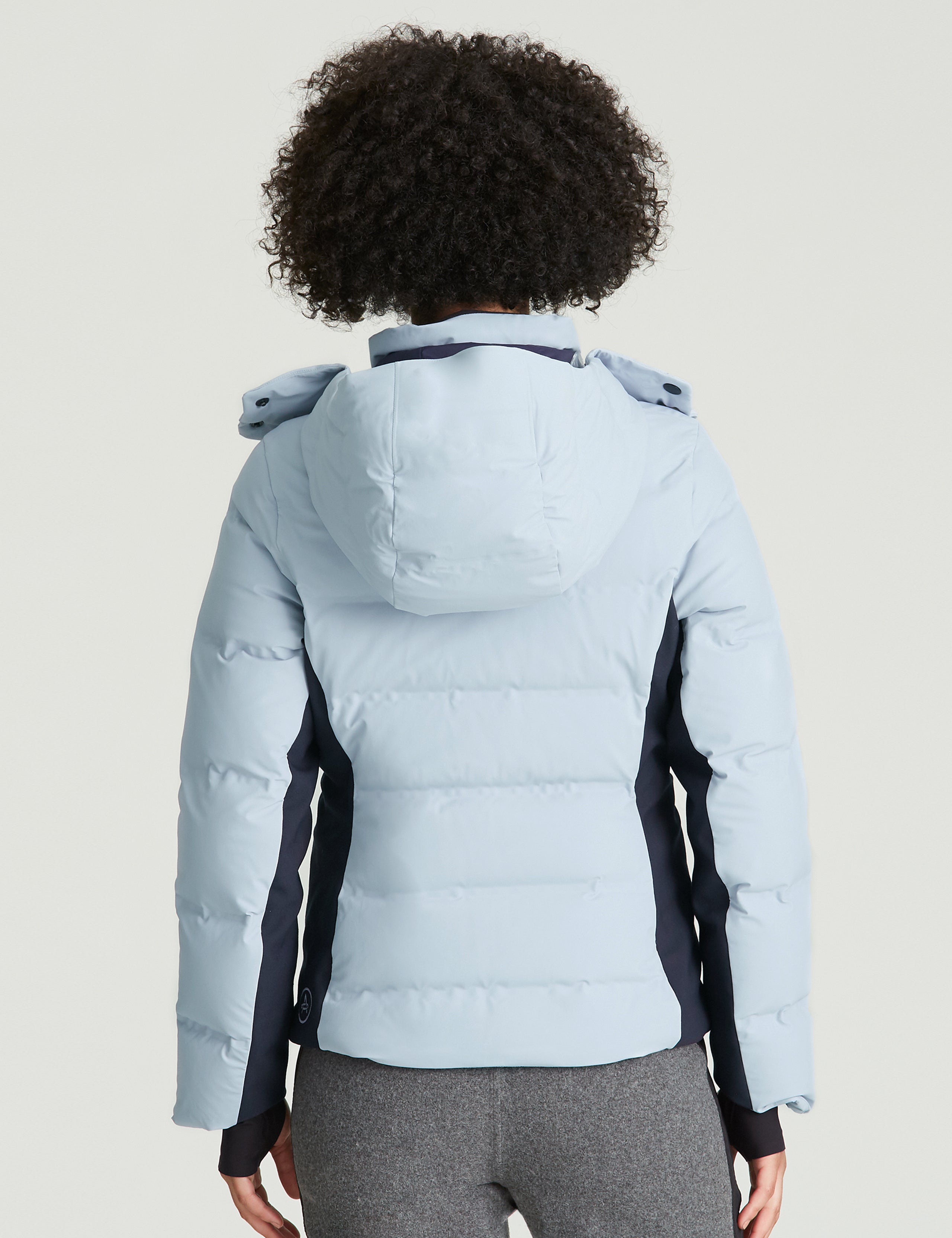 woman wearing light blue ski jacket from Aether Apparel