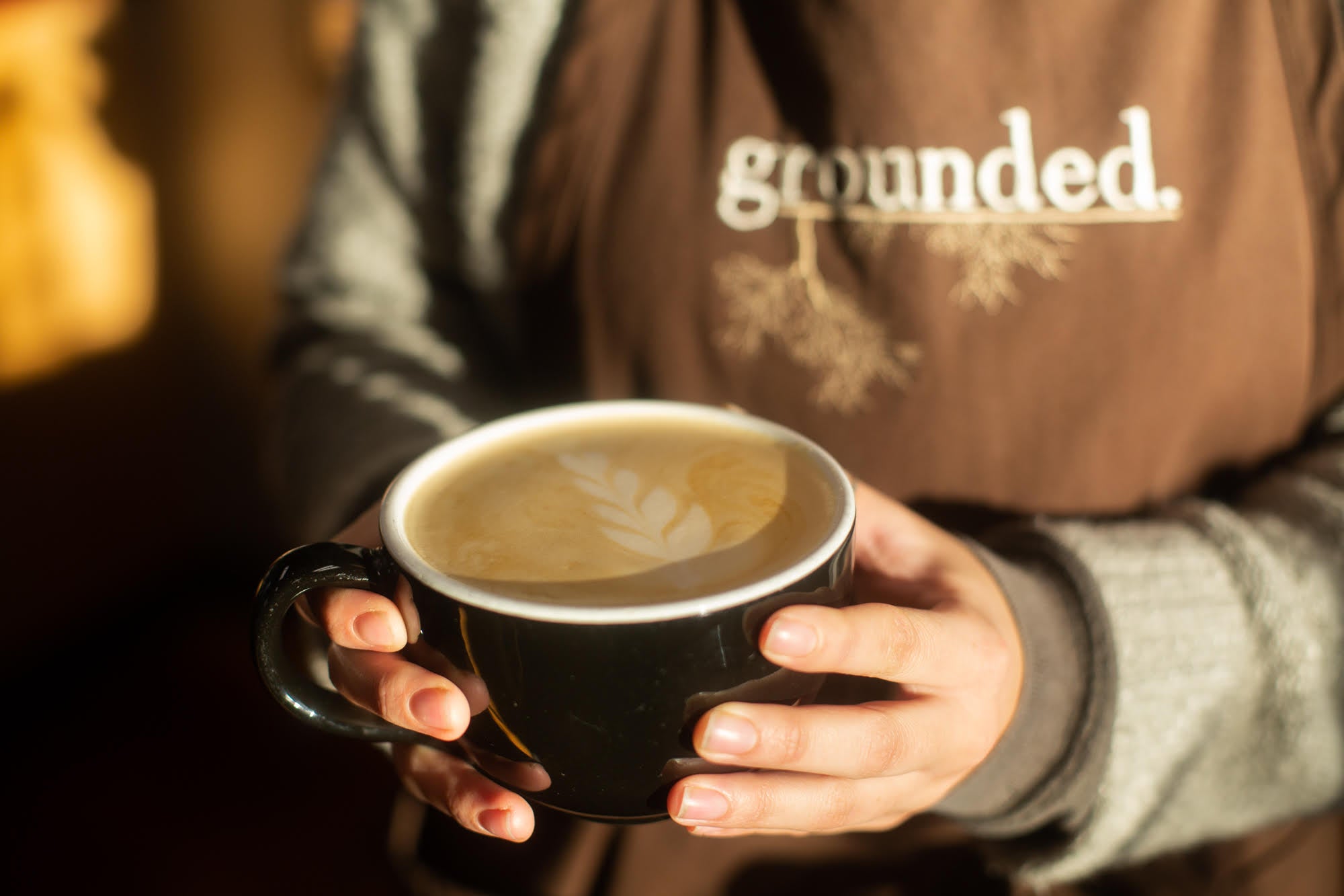 barista holding latte