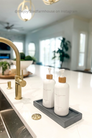 Soap bottle dispensers on tray on kitchen counter