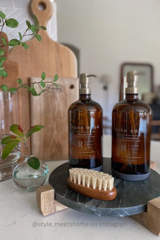 Soap bottle dispensers on tray over kitchen counter