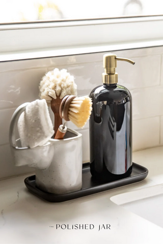 Soap bottle dispenser and dish brush on kitchen sink