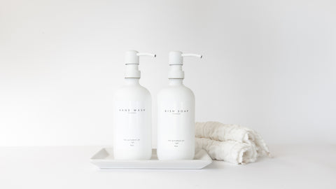 The Polished Jar White Soap Dispensers on white Tray next to Towel