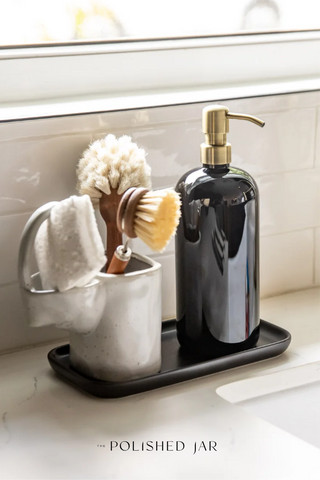 Bottle dispenser on Obsidian ceramic tray next to dish brushes