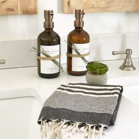 The Polished Jar Soap Bottle Dispenser and Towel on Small Bathroom Counter