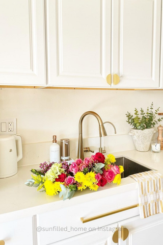 White kitchen with flowers on sink counter