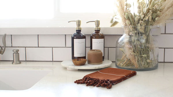 refillable soap bottles by kitchen sink