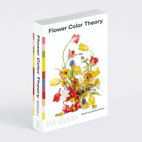 Image of a book with a bright yellow and red flower arrangement on a white background.